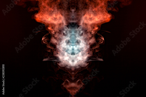 A mystical figure depicting the head of a fox and bringing in flames from multicolored billowing smoke  orange  yellow and white  against a black background.