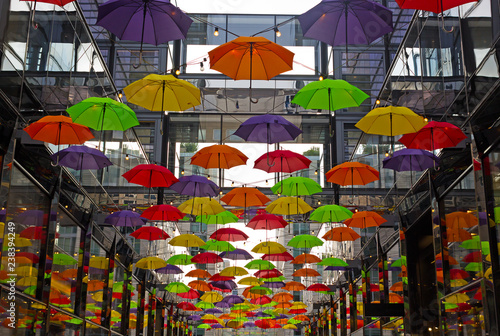 Colorful umbrellas on downtown street in Washington DC, USA. Umbrellas create a cozy friendly atmosphere on the street with shops and restaurants in US capital.