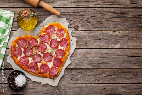 Heart shaped pizza with pepperoni photo