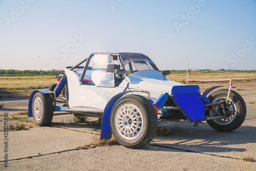 All-wheel drive off-road racing buggy car against the background of a light sky