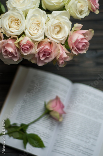 Bouquet of delicate roses and a book