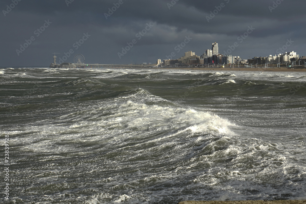 Fototapeta NL. Dark sky and big waves near Scheveningen