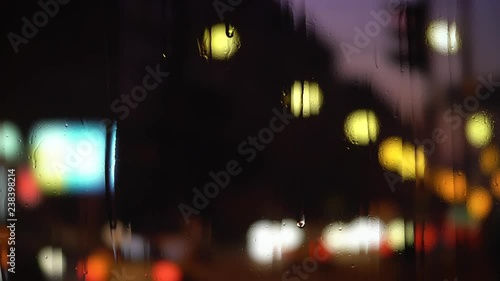 Rain drops on window with traffic in background. Blurry background photo