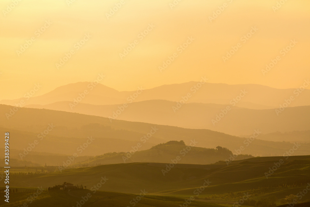 Fototapeta premium Sunset over a rolling landscape