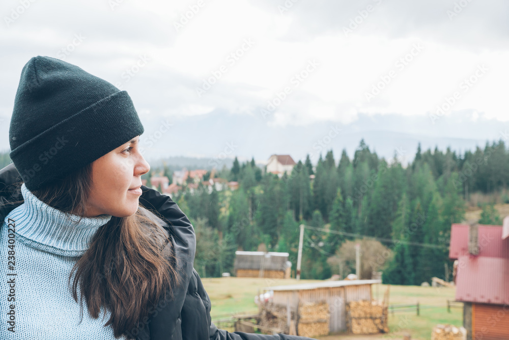 woman standing at balcony with beautiful view of carpathian mountains on background