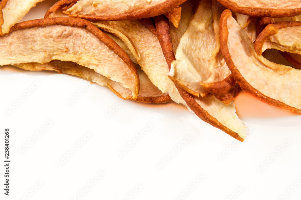 Looking down on a white plate with dried apple slices up close. Not isolated with copy space.