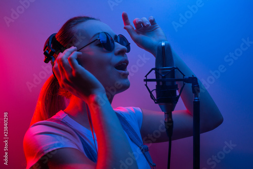 Photography Young beautiful girl records vocals, show business, DJ, party, pop music