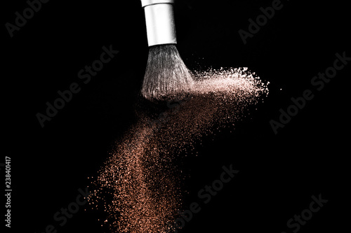 Living Coral Color of the year 2019, powder splash and brush for makeup artist or beauty blogger in black background