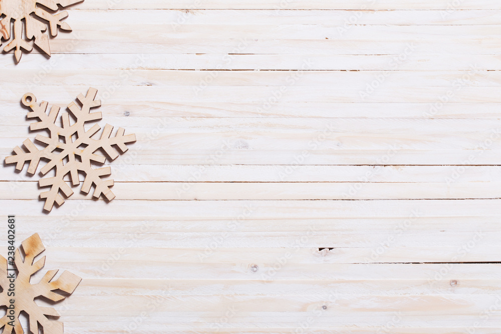 Fototapeta premium Snowflakes on wooden background