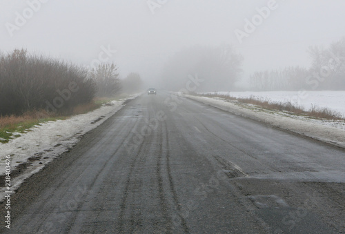 car goes on a bad road to fog