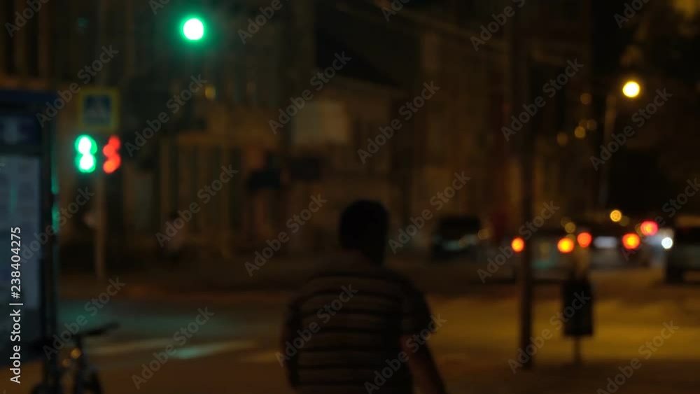 Blurry view of night streets and lights at night. Defocused image of night traffic in the city Blurry view of night streets and lights at night. Defocused image of night traffic in the city