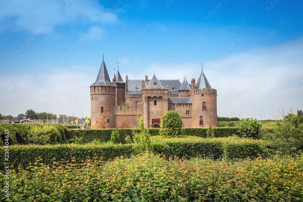 View of the Muiden Castle national museum from the garden in summer View of the Muiden Castle national museum from the garden in summer