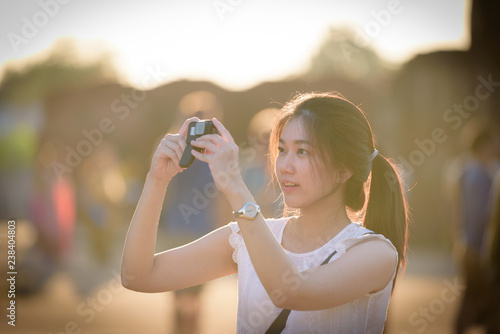 Asian beautiful girl has travel and take a photo at Wat Chaiwatthanaram temple in Ayuthaya, Thailand.