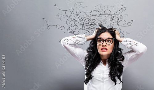Fotografie Solving a problem concept with young business woman feeling stressed