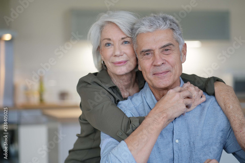  Portrait of loving senior couple in modern home