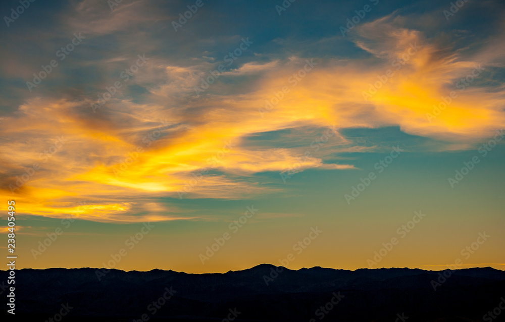 yellow clouds over mountain at sunset