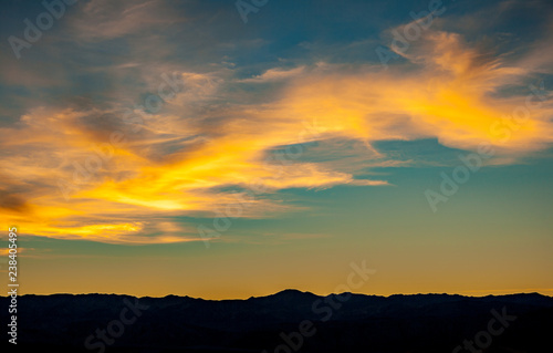 yellow clouds over mountain at sunset