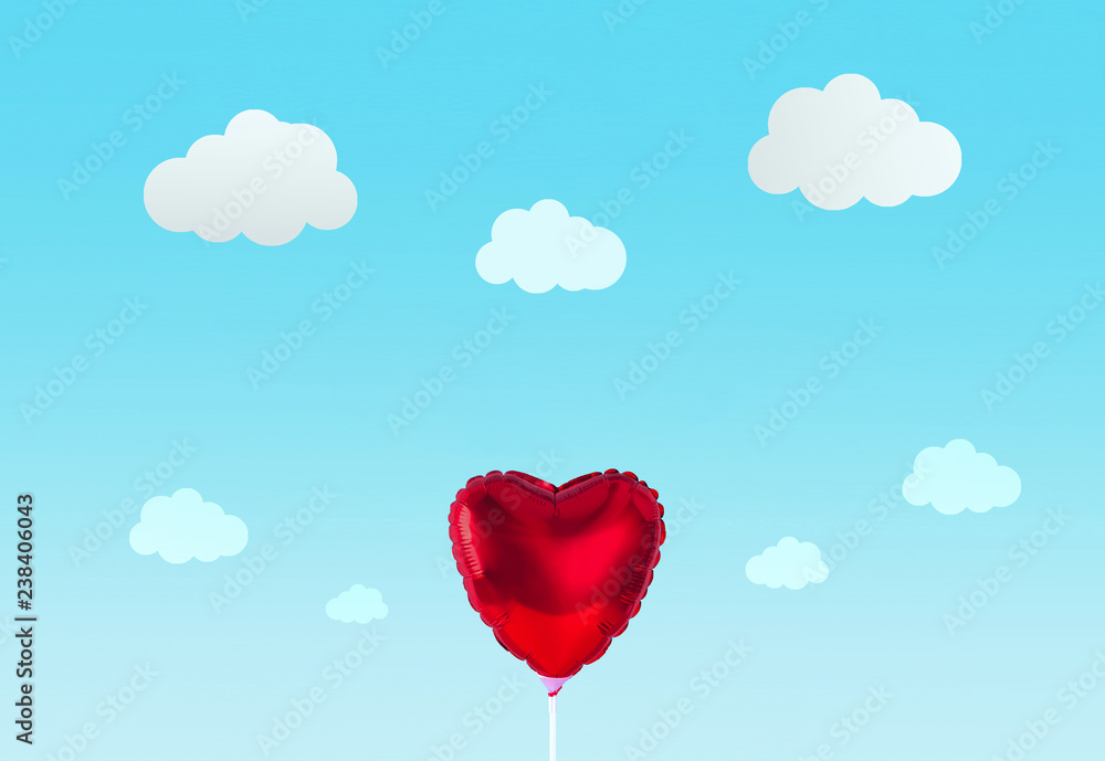 Red heart balloon isolated on blue background.