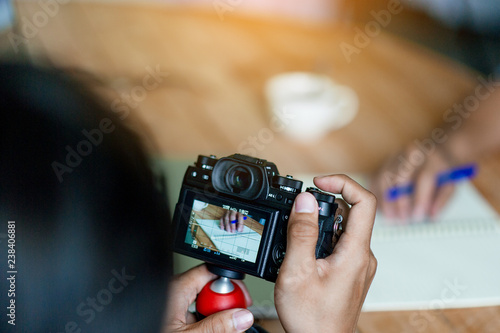 Hand and camera photographers are shooting. Concept photograph with copy space