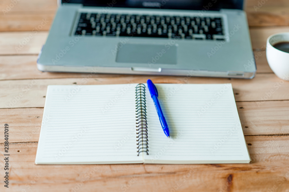 A desk with a business computer and a note on the desk. Business concept with copy space. A desk with a business computer and a note on the desk. Business concept with copy space.