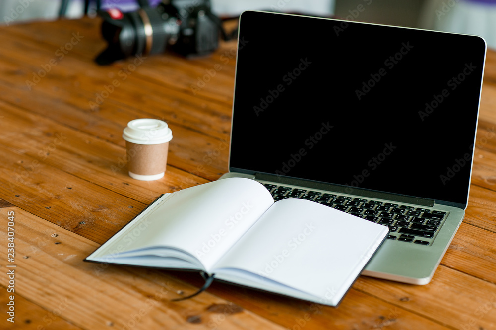A desk with a business computer and a note on the desk. Business concept with copy space. A desk with a business computer and a note on the desk. Business concept with copy space.