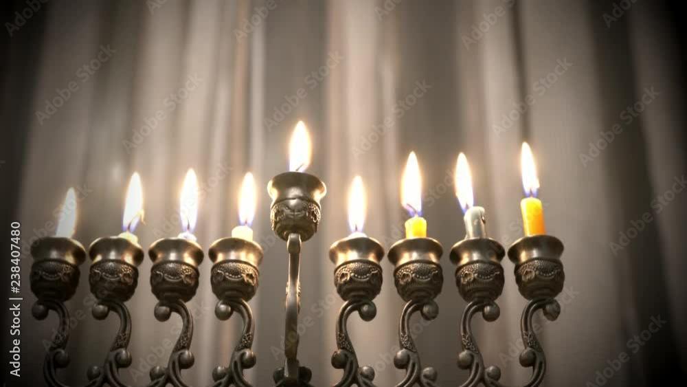 Last eighth day of the Jewish holiday Hanukkah. Nine Hanukkah candles are burning on light curtain background. Blurred view. 4k Last eighth day of the Jewish holiday Hanukkah. Nine Hanukkah candles are burning on light curtain background. Blurred view. 4k
