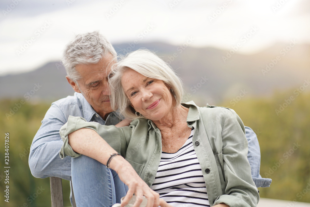 Loving portrait of modern senior couple outdoors
