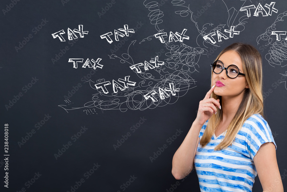 Tax problem theme with young woman in front of a blackboard Tax problem theme with young woman in front of a blackboard