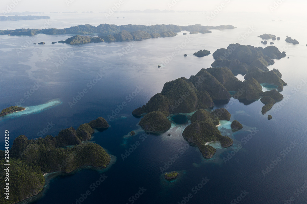 Fototapeta premium Aerial of Peaceful Ocean and Limestone Islands in Misool, Raja Ampat