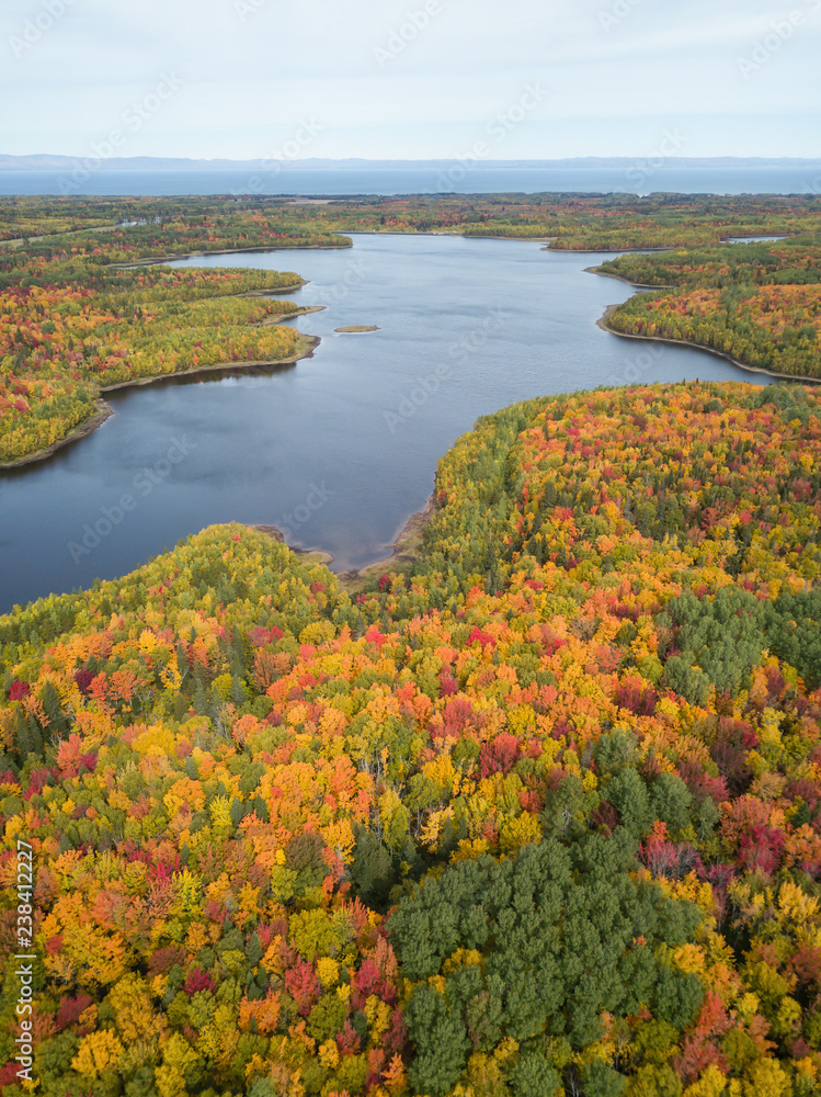 Naklejka premium Aerial view of a beautiful Canadian Landscape during fall color season. Taken near Belledune, New Brunswick, Canada.