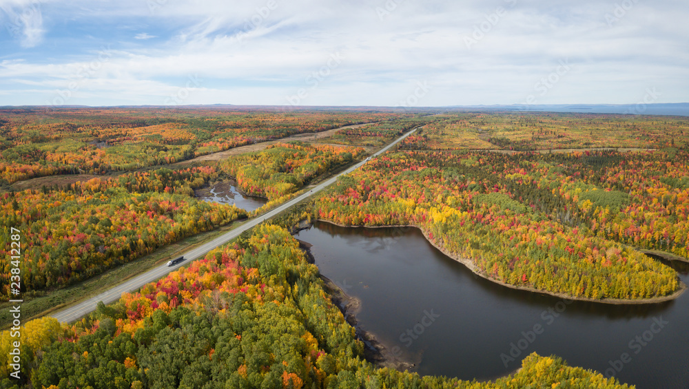 Aerial panoramic view of highway in a beautiful Canadian Landscape during fall color season. Taken near Belledune, New Brunswick, Canada.