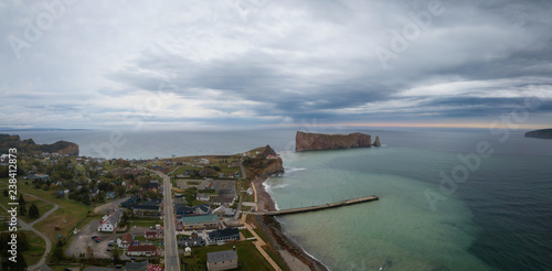 Aerial panoramic view of a beautiful modern town on the Atlantic Ocean Coast during a cloudy sunset. Taken in Percé, Quebec, Canada.