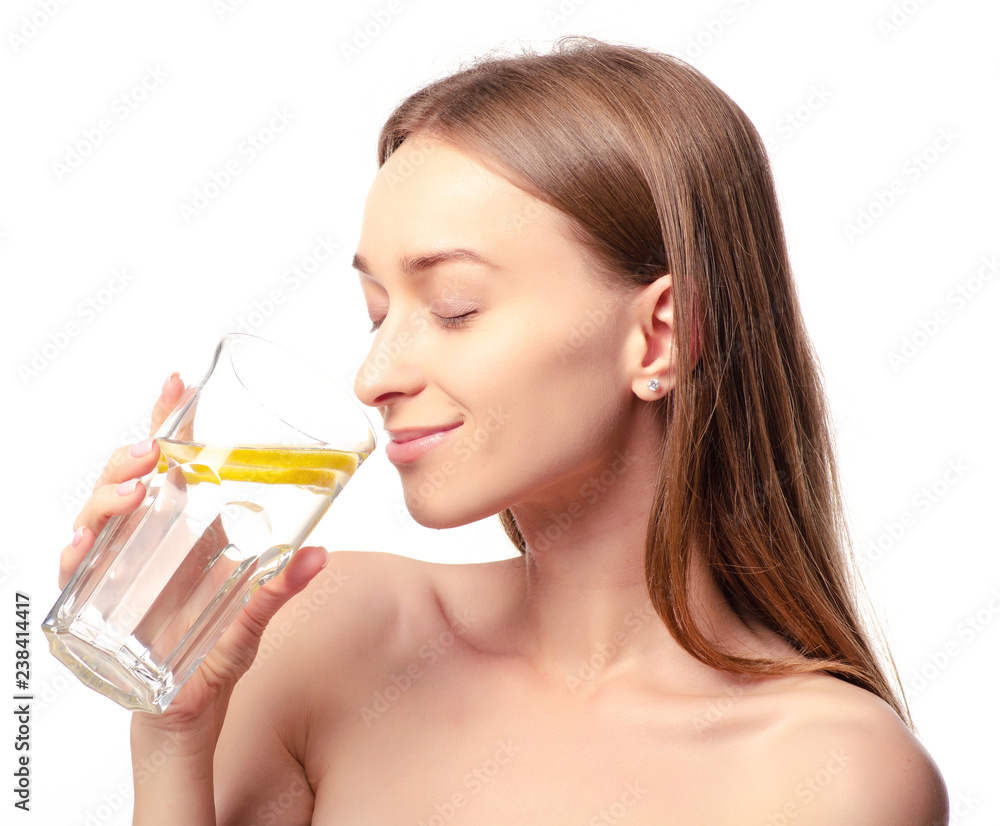 Beautiful woman a glass of water with lemon in hand health beauty on white background isolation Beautiful woman a glass of water with lemon in hand health beauty on white background isolation