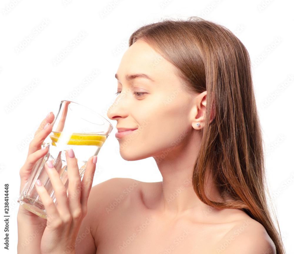Beautiful woman a glass of water with lemon in hand health beauty on white background isolation Beautiful woman a glass of water with lemon in hand health beauty on white background isolation