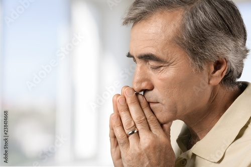 Portrait of a mature man holding his head in pain