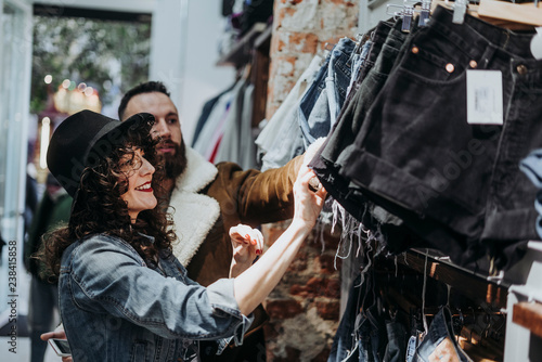 Woman buying clothes at the fashion store with boyfriend