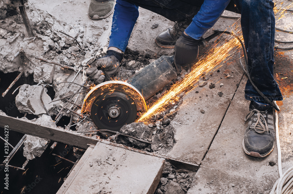 Cutting metal reinforcement in reinforced concrete. Sparks from