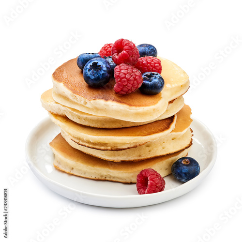 Tasty homemade pancakes with berries on white background