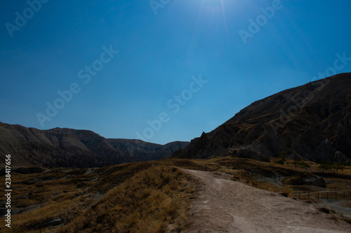 road in mountains against clear blue sky  sunny day