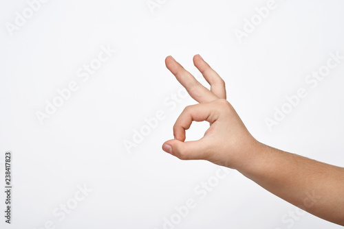 Child hand shows the ok sign.