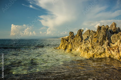Caribbean sea rocky shore line tropic summer landscape with vivid transparent water surface 