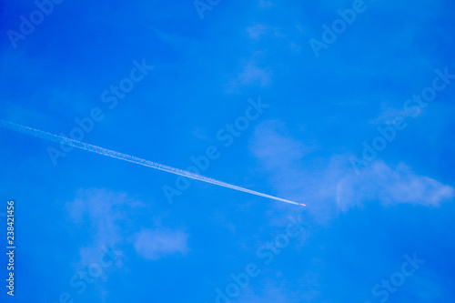 Clearly beautiful blue sky with white line plane.
