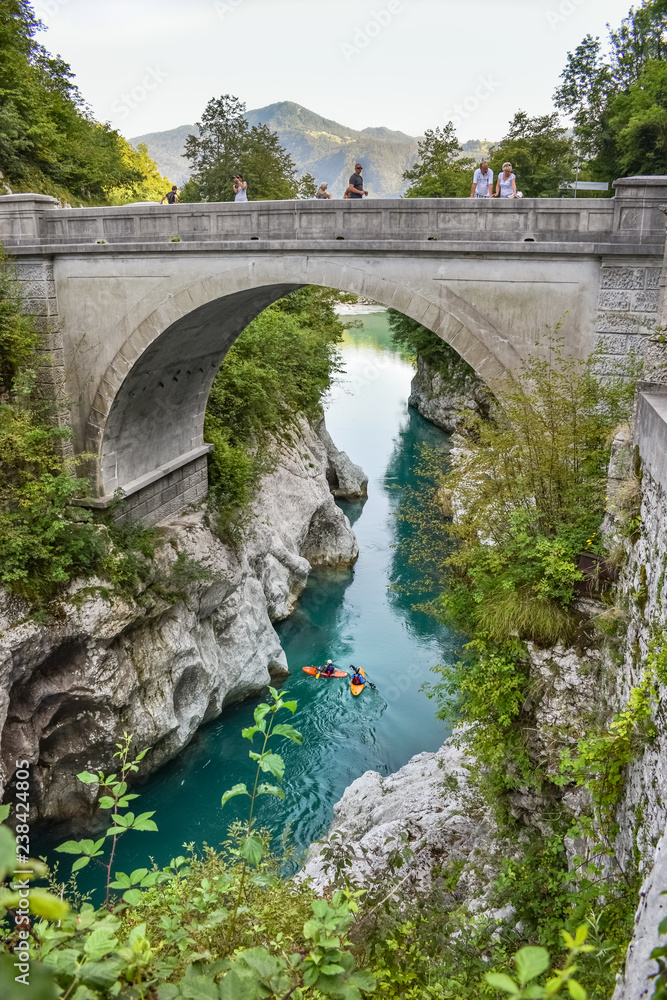 The Napoleon bridge near Kobarid in Slovenia. People are kajaking in the beautiful turquoise colored water of the Soca river