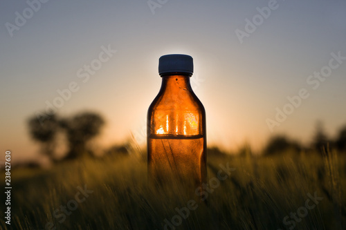 Cereal fields - Natural medicine, bottle. photo