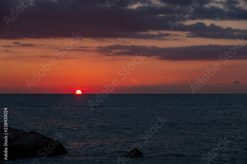 Beautiful sunset view of the beach around Petra tou Romiou, also known as Aphrodite's birthplace, in Paphos, Cyprus. © Iordanis Pallikaras