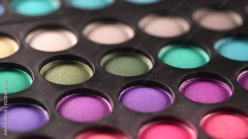 Makeup set. Professional multicolor make up eyeshadows palette, bright vivid colors and tints of eye shadows set background. Dolly shot. 4K UHD video footage. 3840X2160 Makeup set. Professional multicolor make up eyeshadows palette, bright vivid colors and tints of eye shadows set background. Dolly shot. 4K UHD video footage. 3840X2160