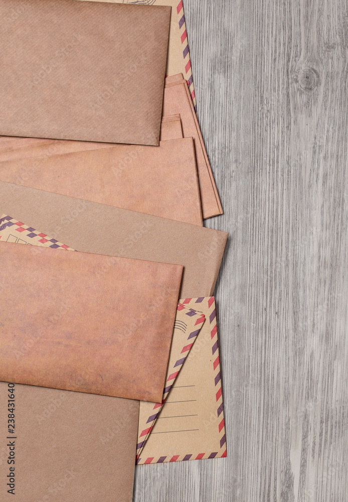 Fototapeta premium Stack of envelopes on wooden