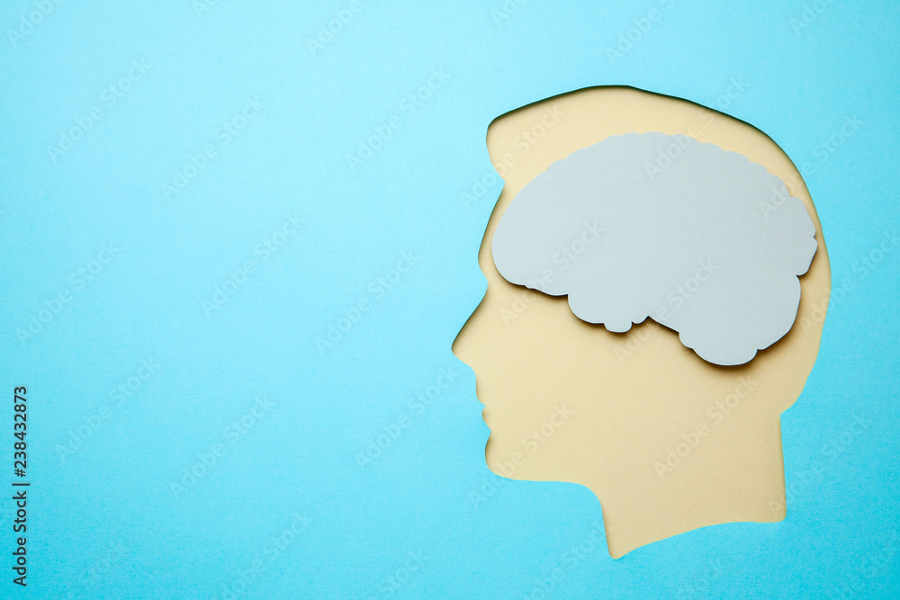 Silhouette of man and a brain inside head on blue background. Copy space for text. Silhouette of man and a brain inside head on blue background. Copy space for text.