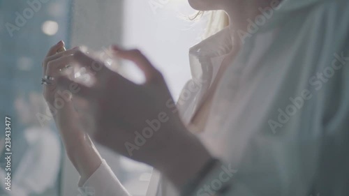 girl uses perfume close up.