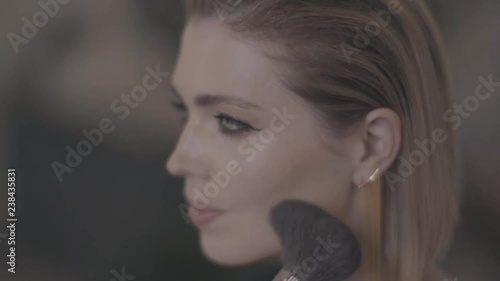 girl put on the makeup close-up.